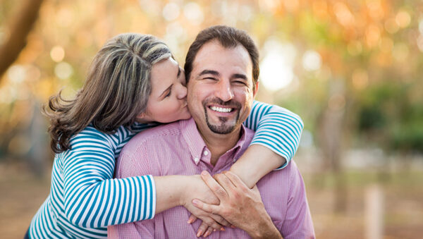 Mature woman kissing her husband in and horizontal shot.