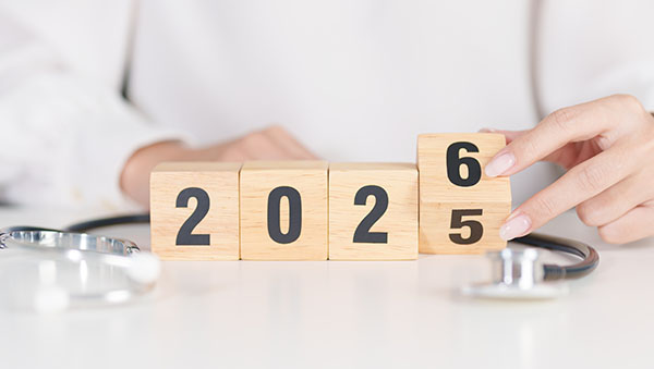 2025 end year to Happy New Year 2026 with Stethoscope of doctor on table. 